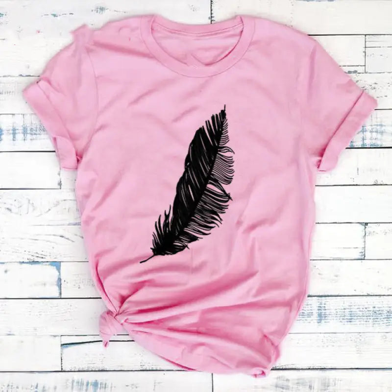 a pink shirt with a black feather on it