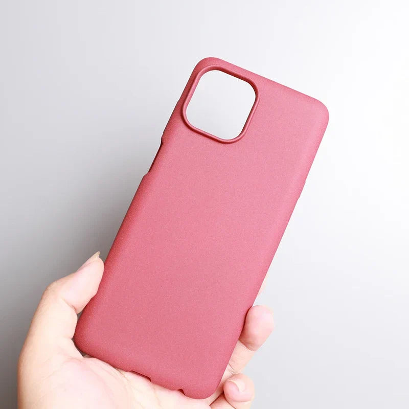 Pink smartphone case held in a hand.