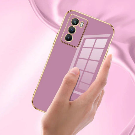 Pink smartphone with gold trim and a triple camera setup.