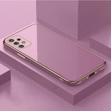 Pink smartphone with a gold-trimmed edge and multiple camera lenses.