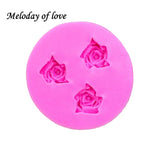 a pink soap with a rose shaped design on it