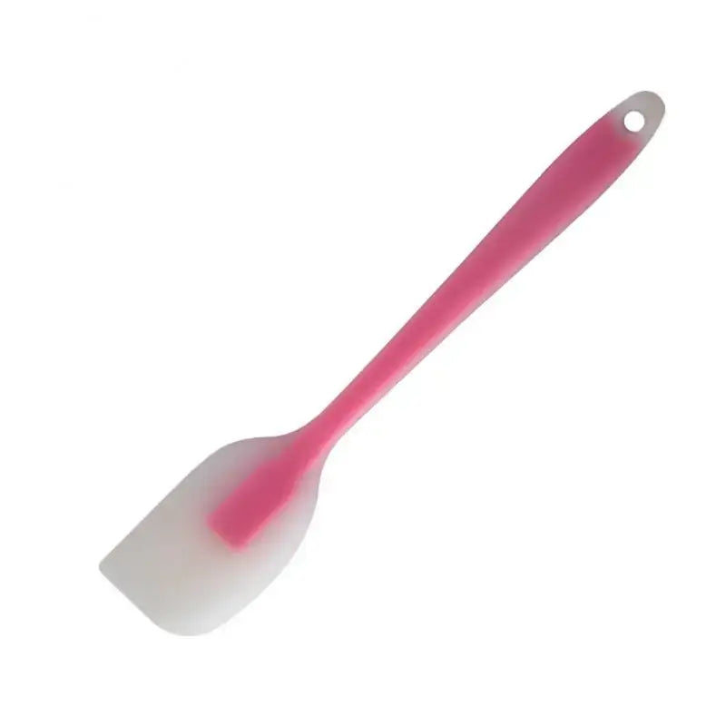 A pink spat with a white handle