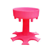 a pink plastic stool with a small hole in the middle