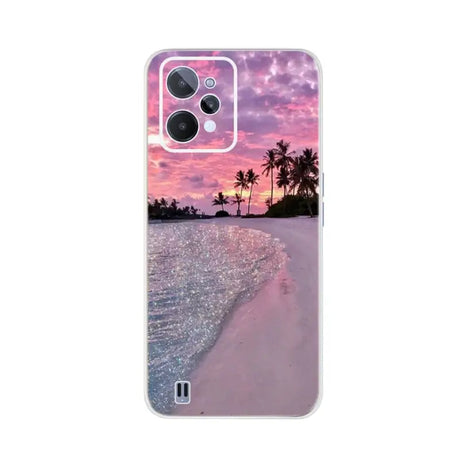 a pink sunset on the beach with palm trees and a pink sky