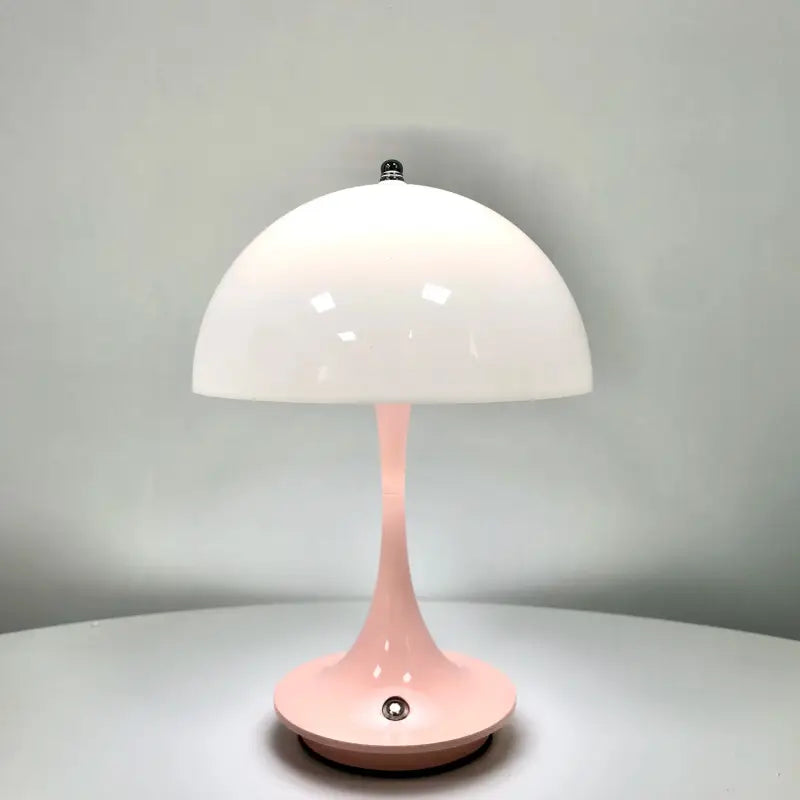 a pink table lamp on a white table
