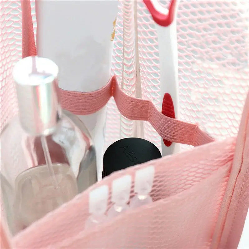 a pink mesh bag with a bottle and a bottle