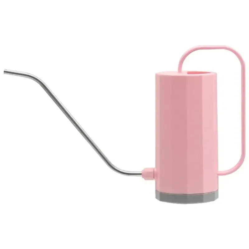 there is a pink tea kettle with a metal handle and a straw