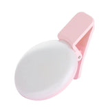 a pink and white toilet seat with a plastic lid