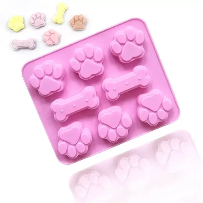 a pink tray with a dog bone shaped cookie cutter