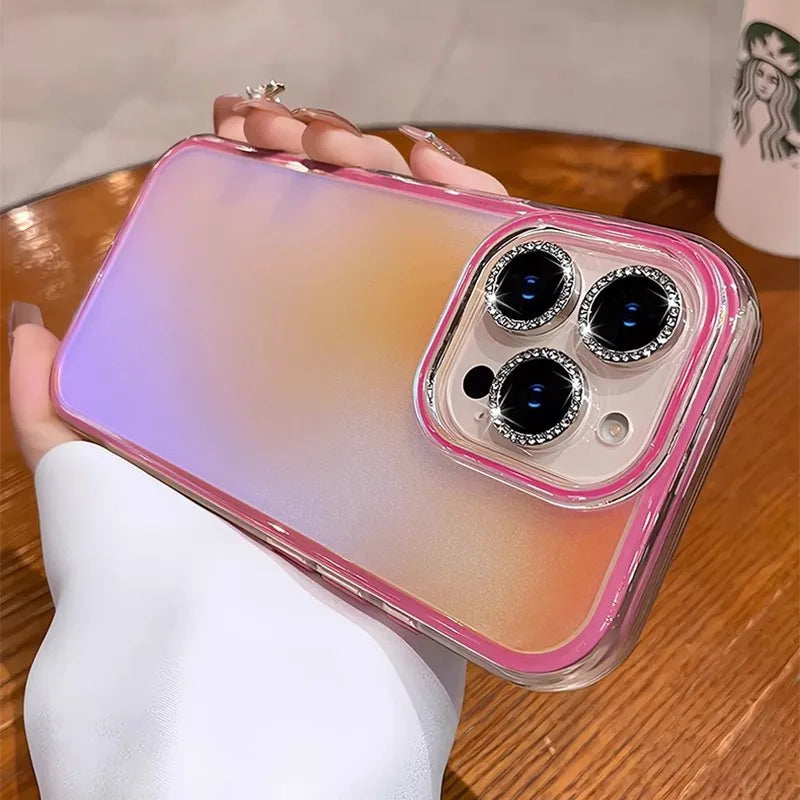 Pink-trimmed phone case with jeweled camera lenses.