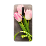 a pink tulip with green leaves and flowers on a white background