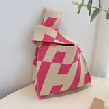 a pink and white bag sitting on a table