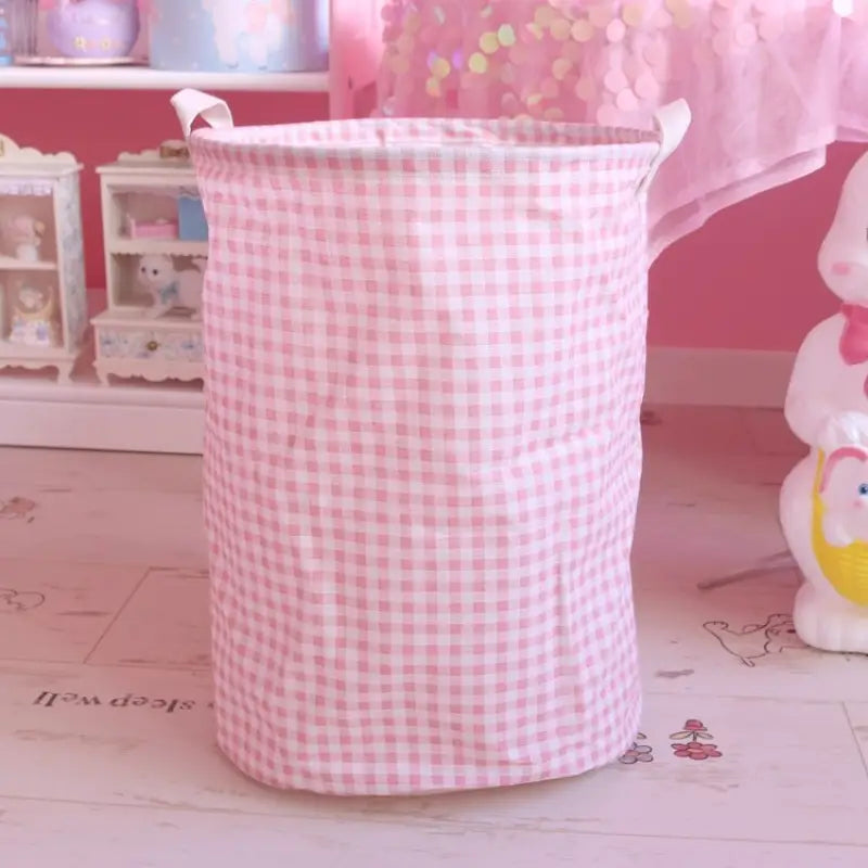 a pink and white basket sitting on top of a table