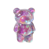 there is a small glass bear that is sitting on a table