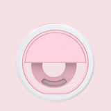 a pink and white circular object with a circular hole