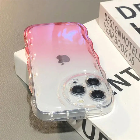 A pink and white iphone case sitting on top of a box