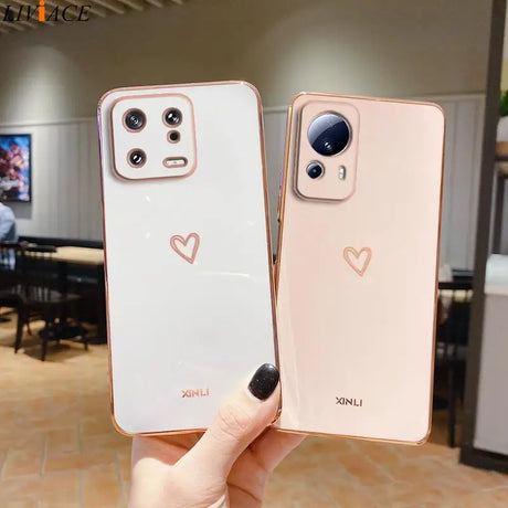 two iphones with heart - shaped faces