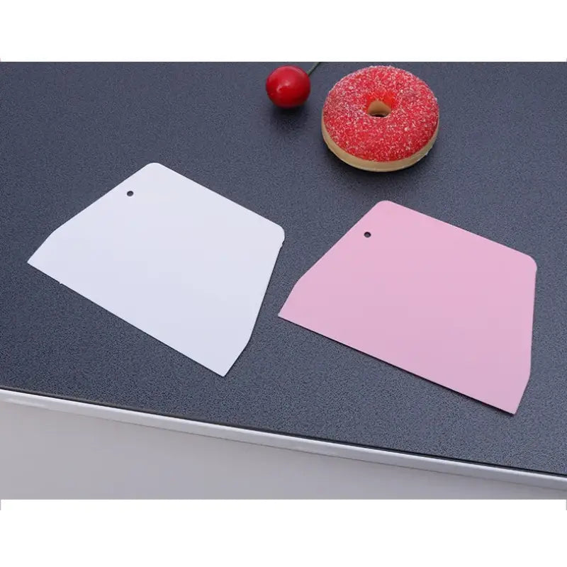 a pink and white paper tag on a black counter