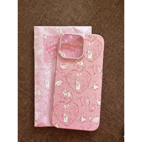 A pink and white phone case with a pattern of cats