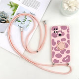 a pink and white cow print phone case with a pink strap