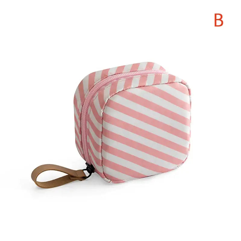 a pink and white striped cosmetic bag
