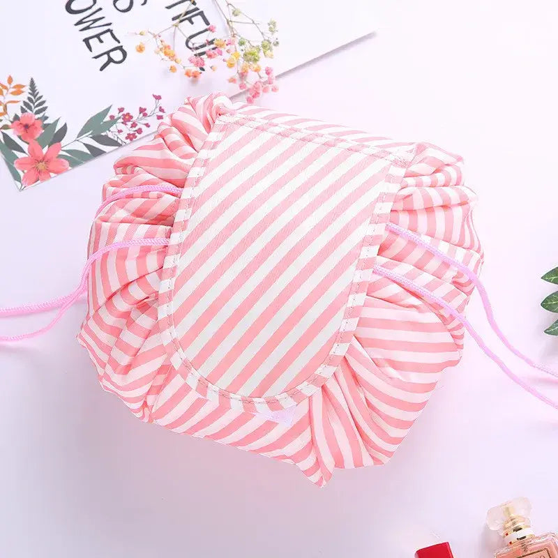 a pink and white striped draws bag with a pink ribbon