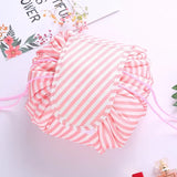 a pink and white striped draws bag with a pink ribbon