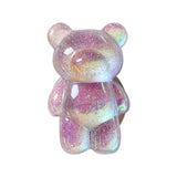 a pink and white teddy bear with glitter on it