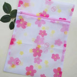 a pink and yellow flower print bag with a pink flower print on it
