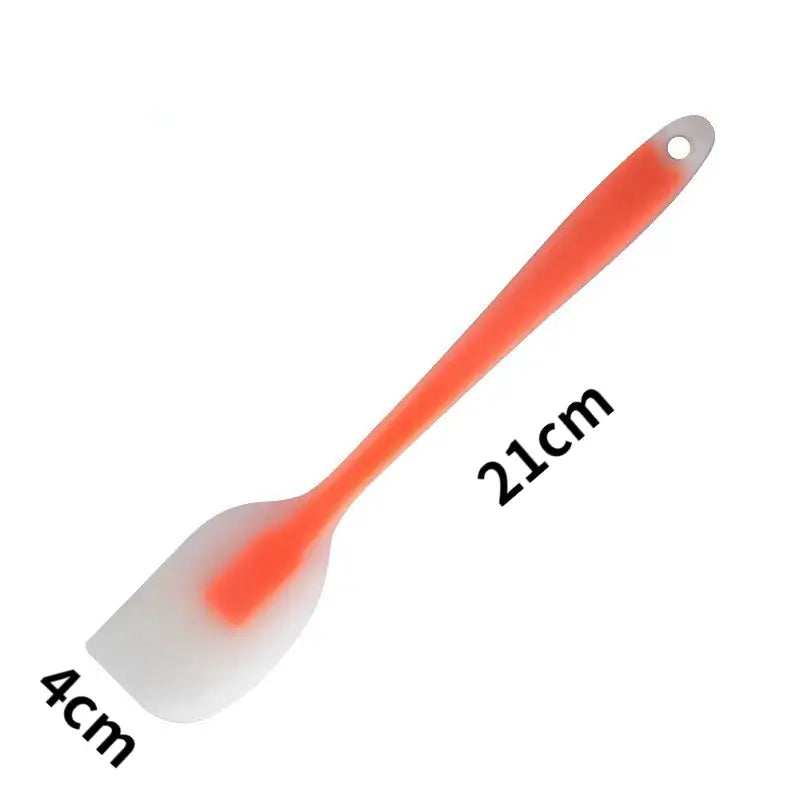 a plastic spat with a red handle