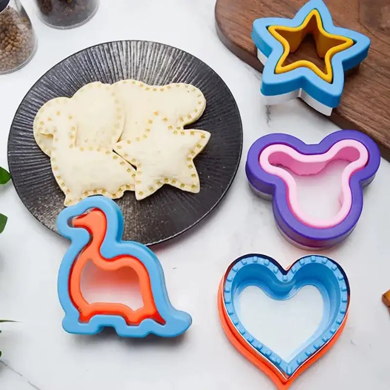 a plate with cookies and cookie cutters on it