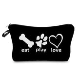 a black cosmetic bag with white text that says eat play love