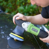a man using a sander to polish a car