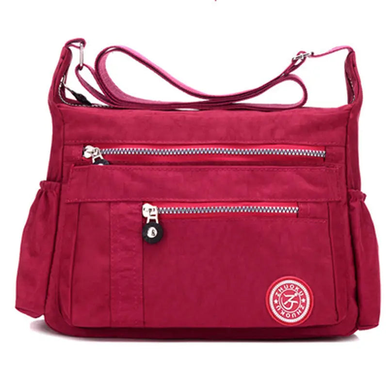 a red bag with zippers and a zippered pocket