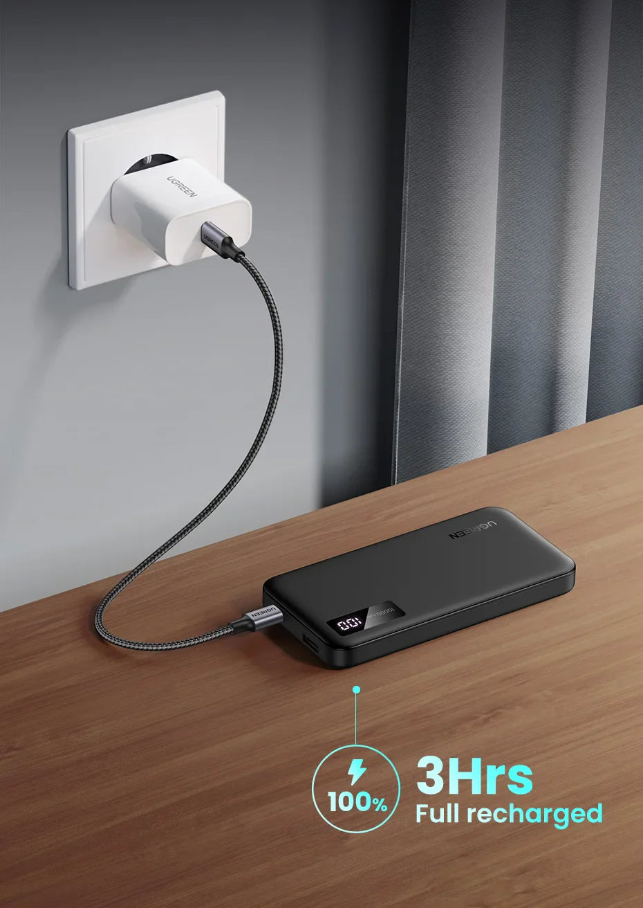 Portable battery charger or power bank connected to a wall outlet.