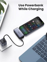 Portable battery charger (powerbank) connected to a smartphone.