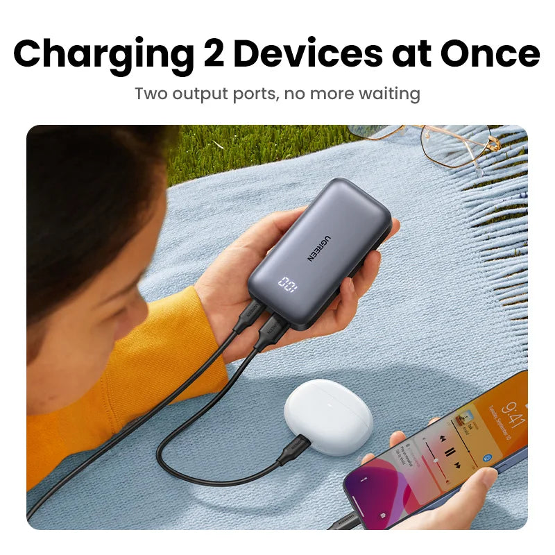 Portable battery charger with two output ports for simultaneously charging multiple devices.