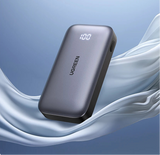 Portable battery pack or power bank with a digital display showing ’100’’.