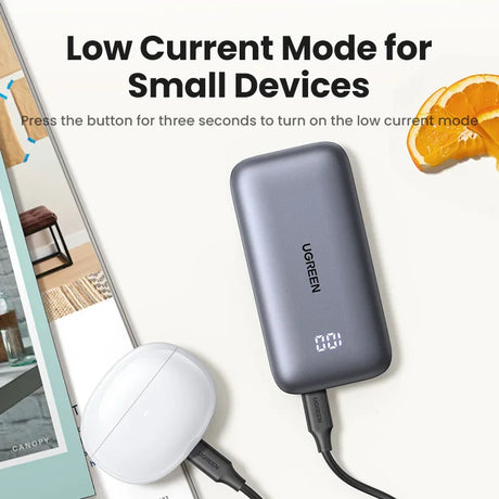 Portable battery pack or power bank with a digital display showing battery percentage.