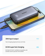 Portable battery pack or power bank sitting on a smartphone.