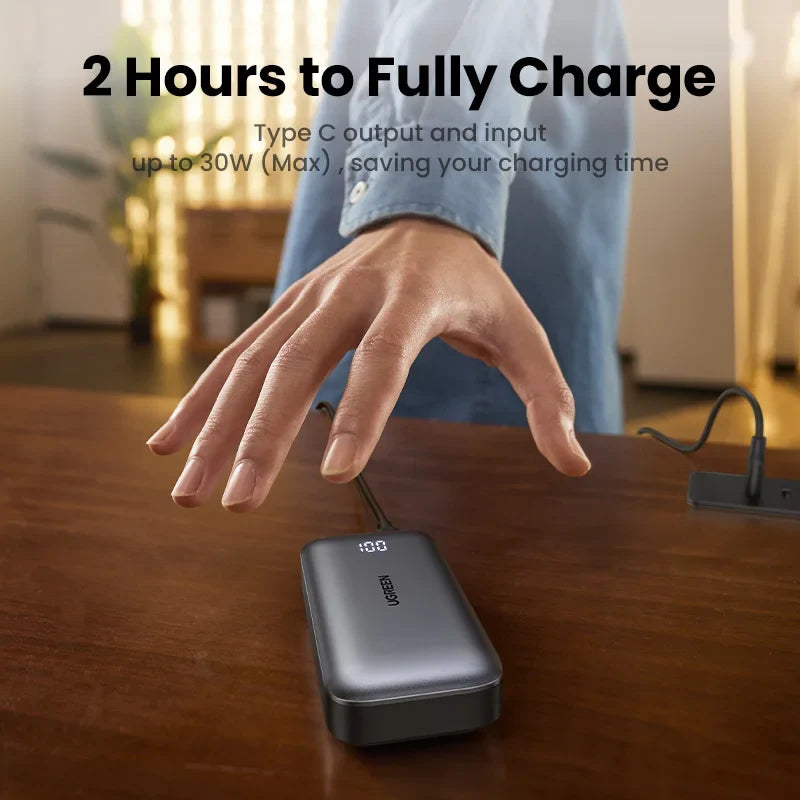 Portable power bank or external battery charger on a wooden surface.