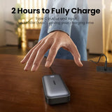 Portable power bank or external battery charger on a wooden surface.