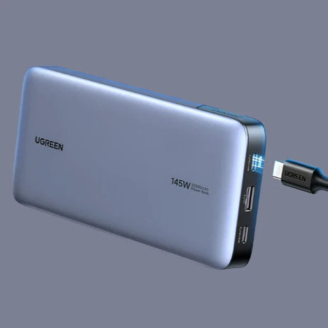 Portable power bank with USB ports and a digital display.