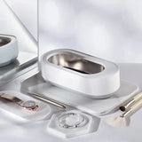 a white bathroom set with a mirror and a silver tray