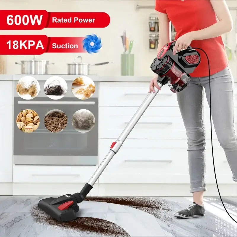 a woman vacuuming a kitchen floor with a vacuum