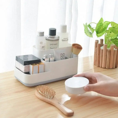 a person holding a cup and brush on a table