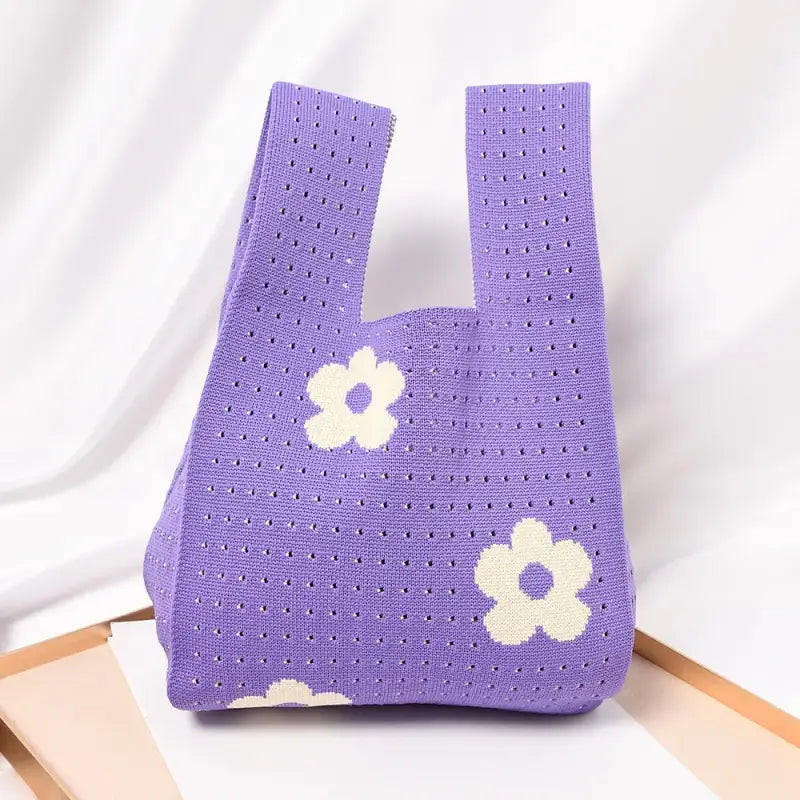 a purple bag with white flowers on it