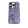 the back of a purple phone case with a pattern of blue and pink crystals