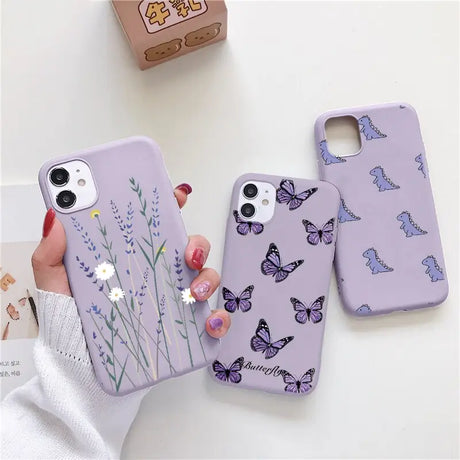 a woman holding a purple phone case with butterflies on it