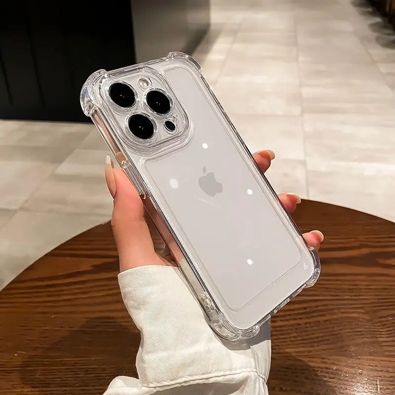 a person holding a clear case with a white iphone